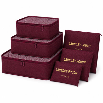 A set of burgundy fabric travel organizers and pouches with gold lettering, including three rectangular zippered boxes, two flat pouches, and one zippered laundry pouch, arranged on a white background.