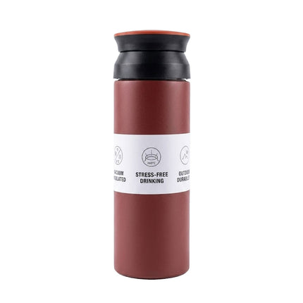 Red and black insulated travel mug with a white label on a white background