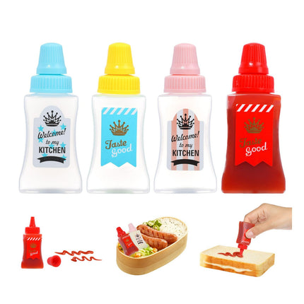 Set of four condiment bottles with colorful caps and labels, one being used to spread ketchup on a sandwich.
