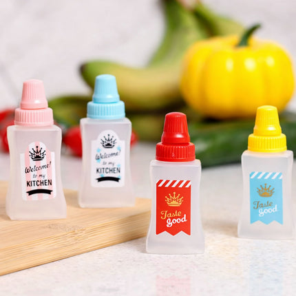 Four small bottles with colorful lids on a wooden board with fruits in the background