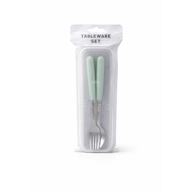 Tableware set with light green handles in clear packaging on a white background