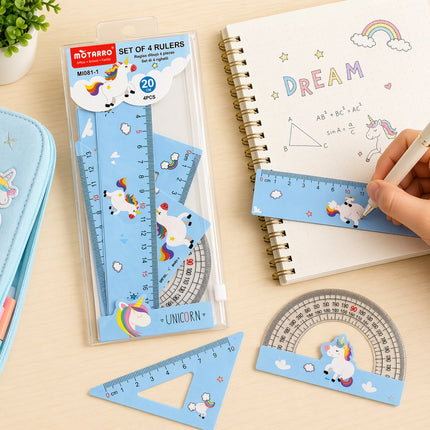 Set of unicorn-themed rulers and protractors on a desk with a notebook.