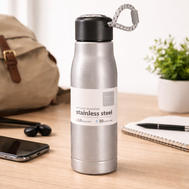 Stainless steel water bottle on a desk with a backpack, phone, and notebook in the background