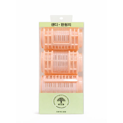 Pack of hair rollers with a green label on a white background