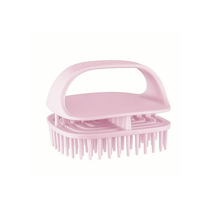 Pink scalp massage brush on a white background