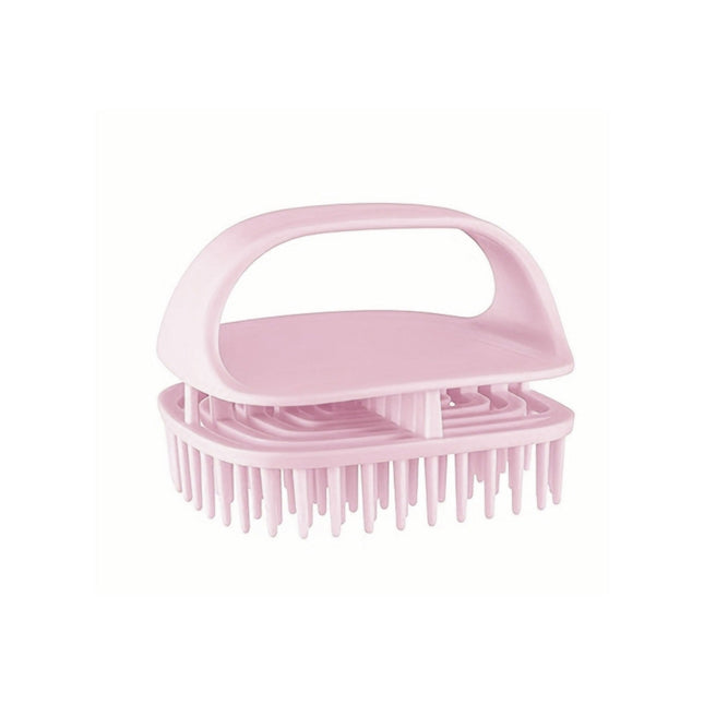 Pink scalp massage brush on a white background