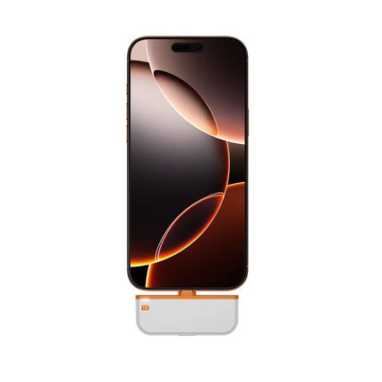 A smartphone with a dark abstract wallpaper is shown vertically on a white background, with a small white and orange accessory dock or stand attached below the bottom edge of the phone.