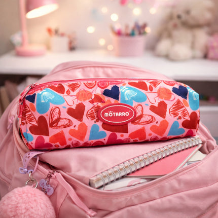 Pink pencil case with heart patterns on a pink backpack
